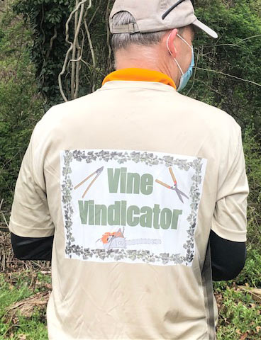 volunteer wearing vine vindicator t-shirt